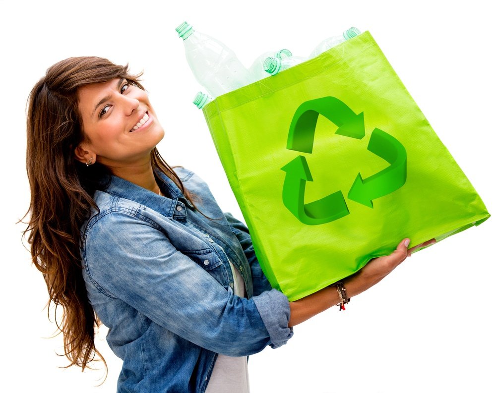 1 - Girl holding a green reusable bag with plastic bottles inside.jpg