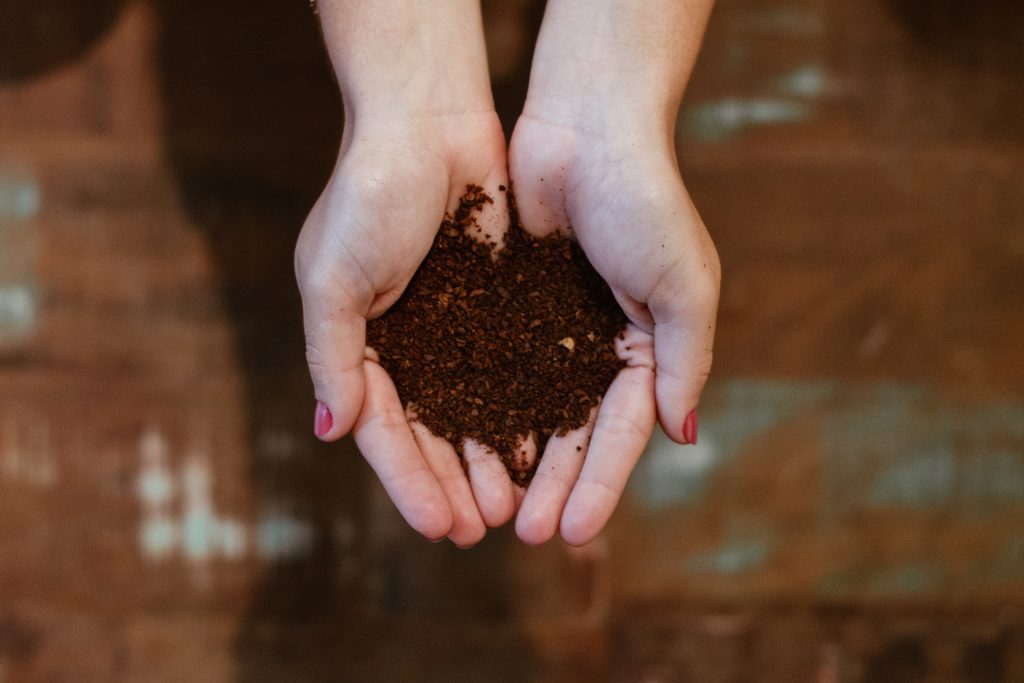 Hands holding dirt for composting