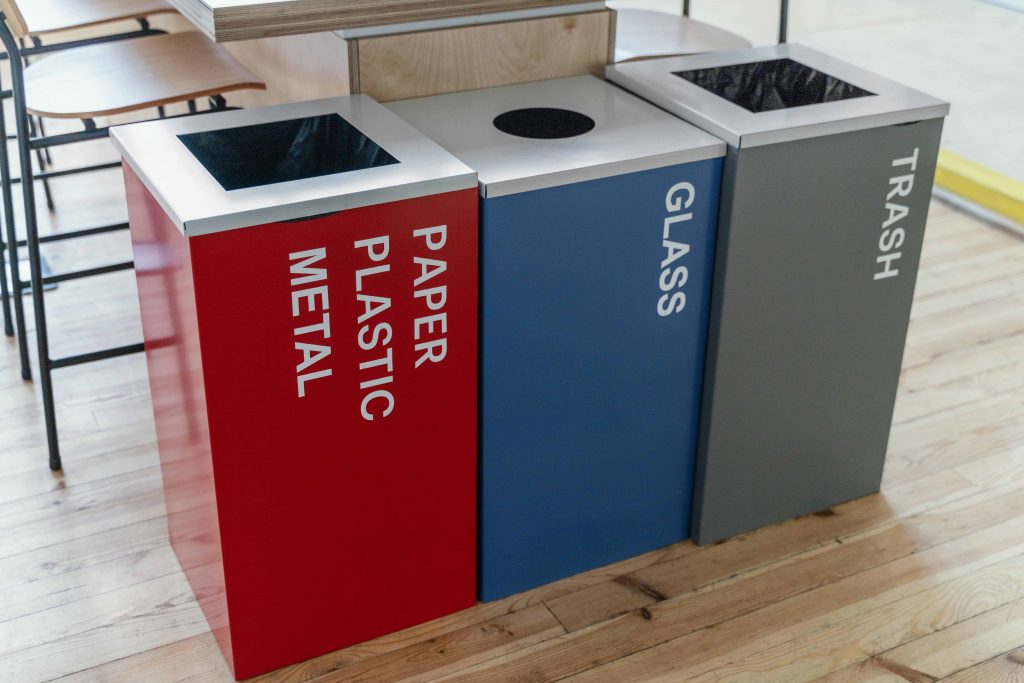 Clearly labeled waste and recycling bins