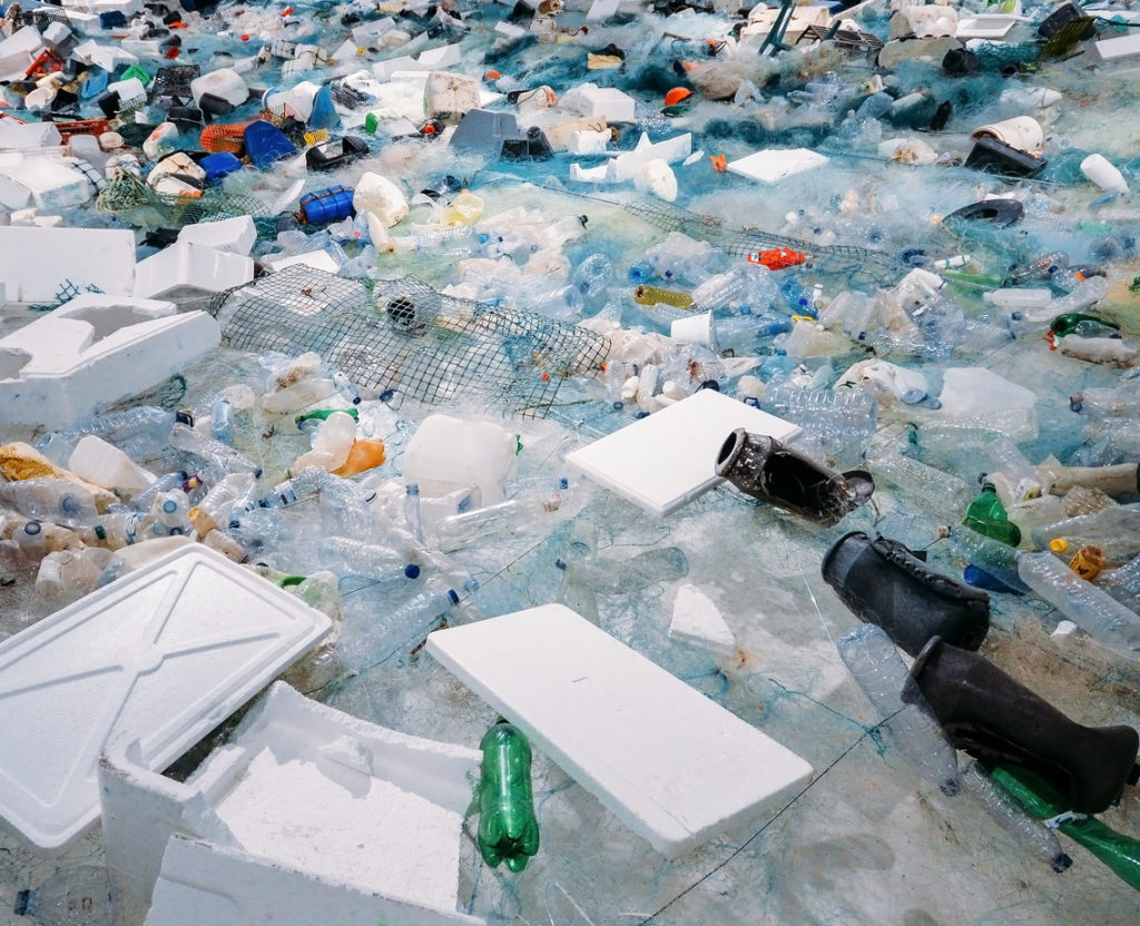 Pile of waste plastic bottles, Styrofoam, and other trash