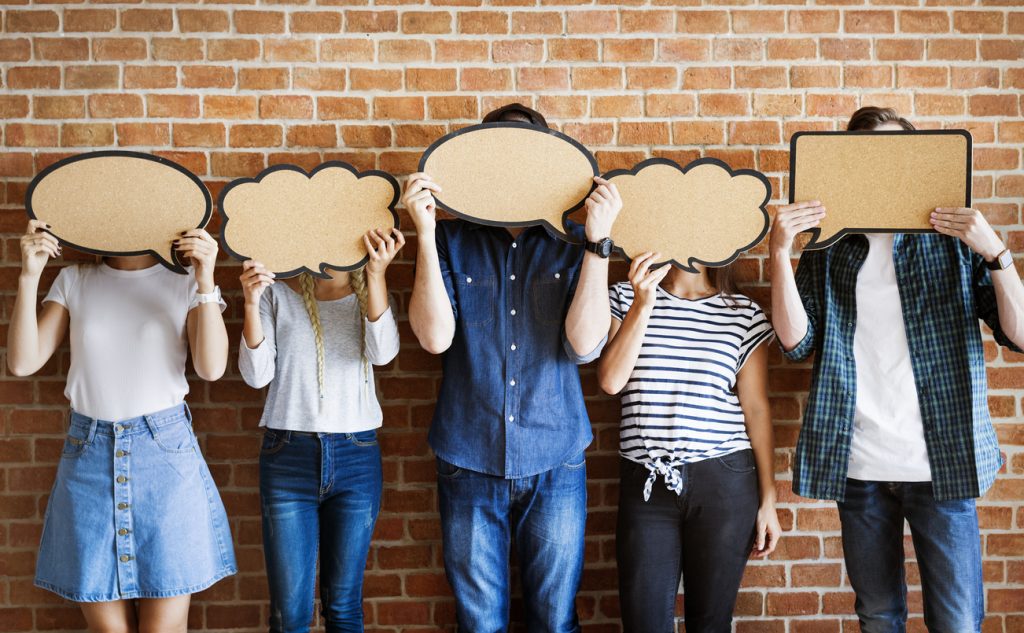 Young adults holding up copy-space placard thought bubbles