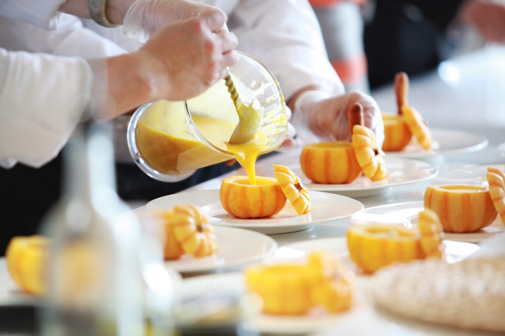 pumpkin soup being served in mini pumpkins