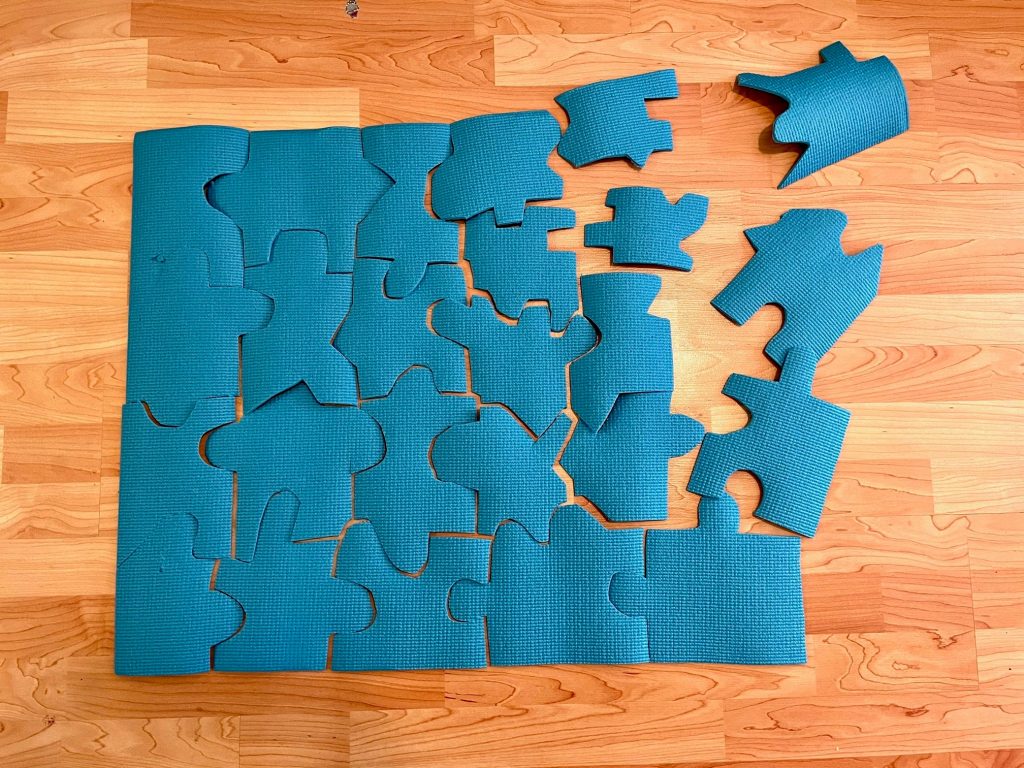 Old yoga mat cut into a floor puzzle