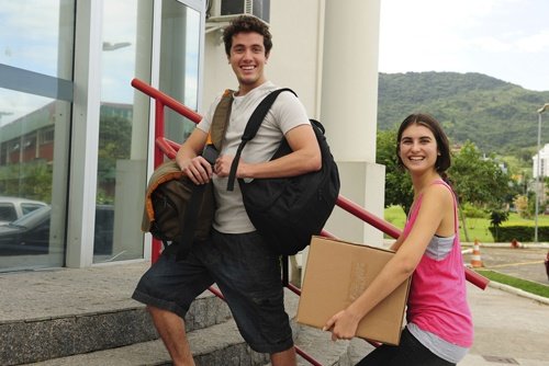 Students moving in with cardboard boxes