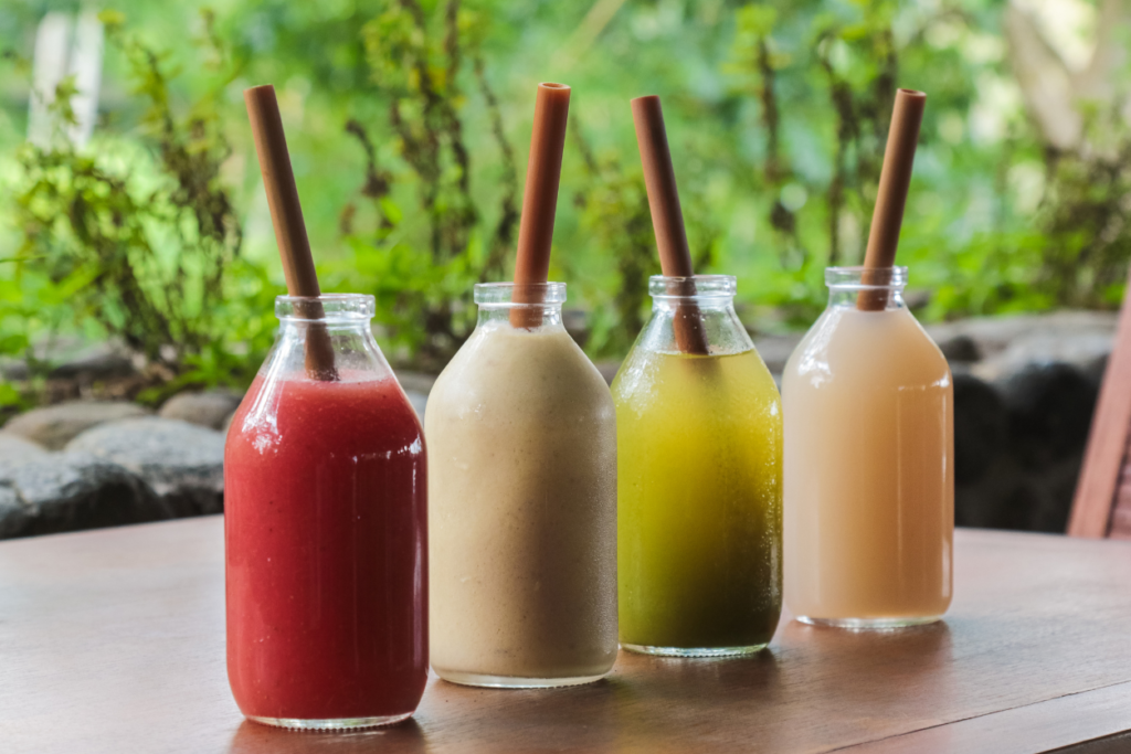 frozen tropical drinks inside glass jars with bamboo straws