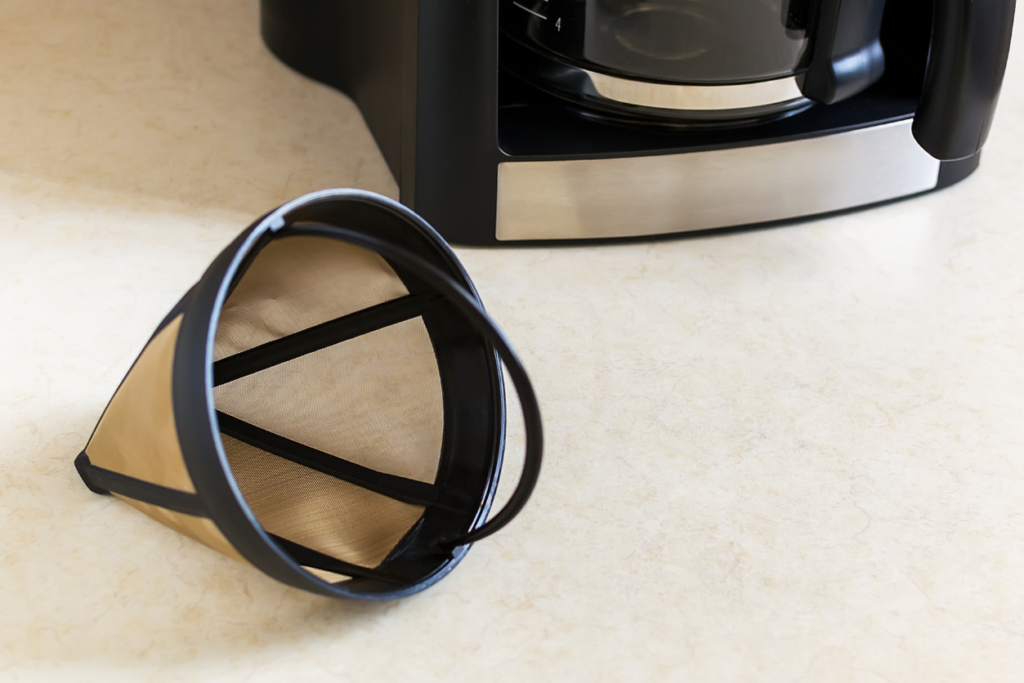 reusable coffee filter next to a coffee machine