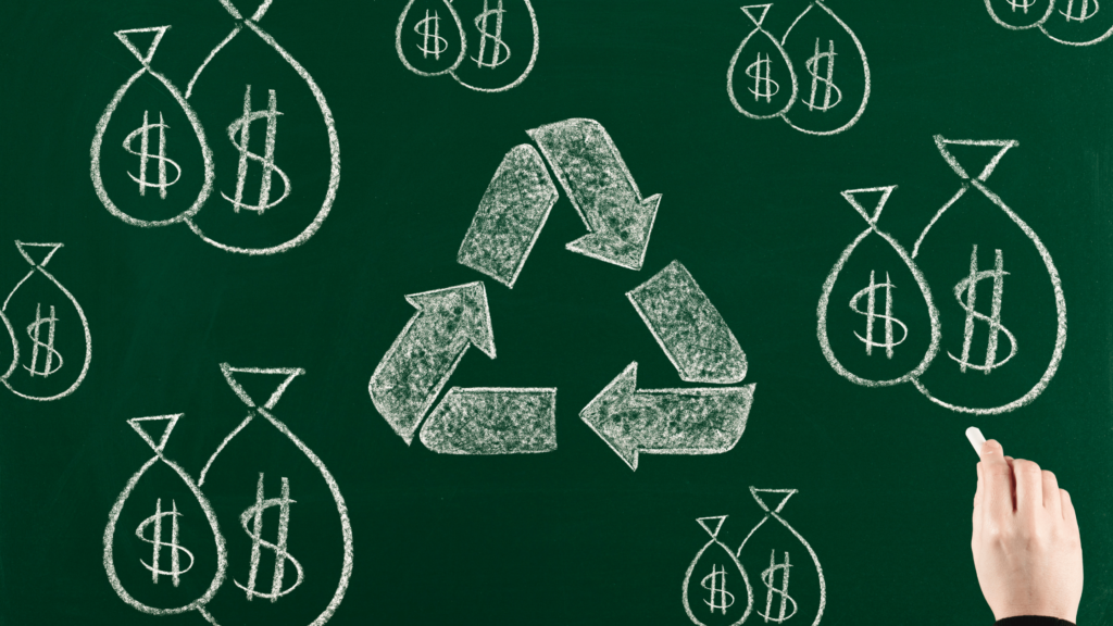 hand drawing recycling loop and bags of money on chalkboard.